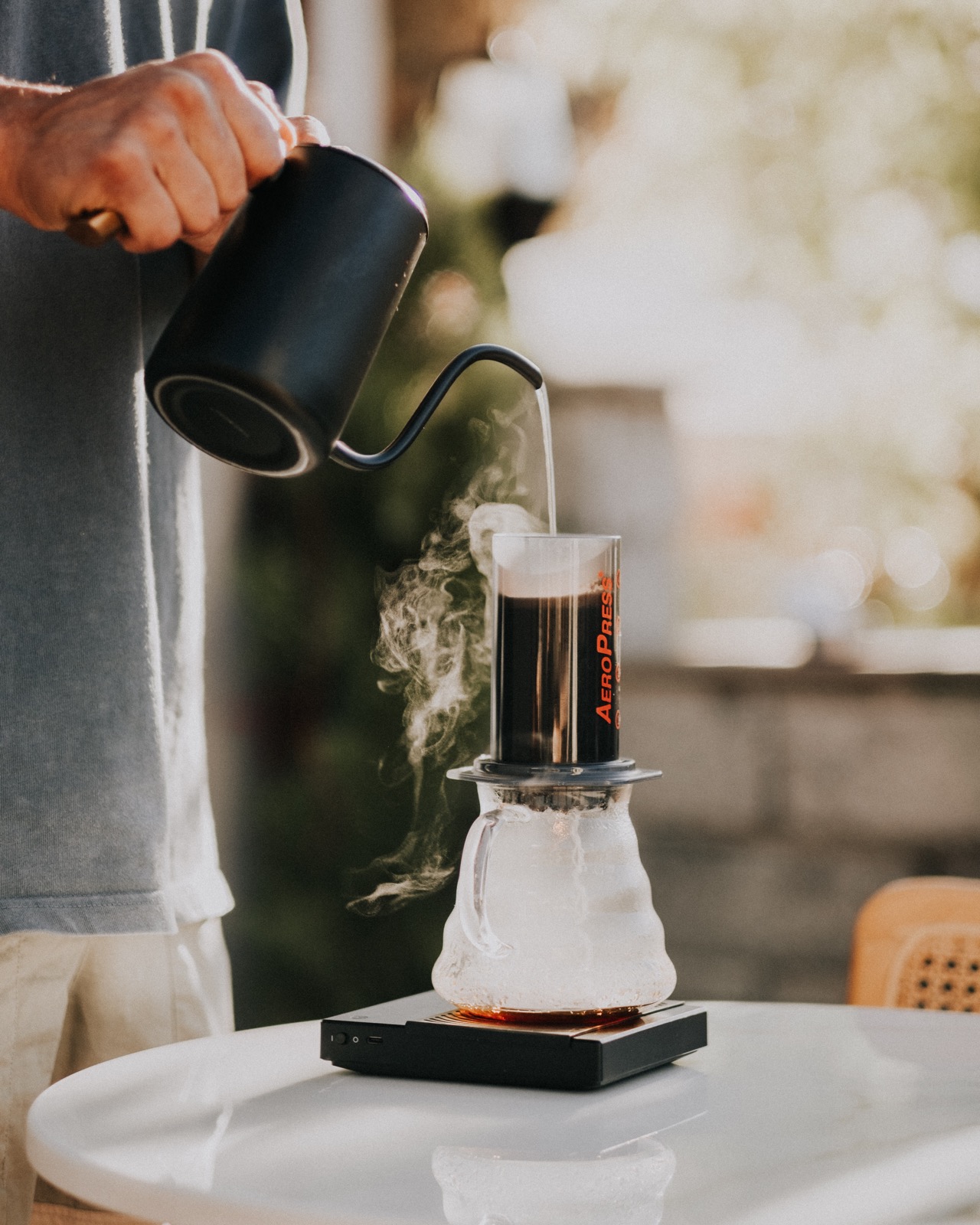 Barista making brewing coffee with the Aeropress